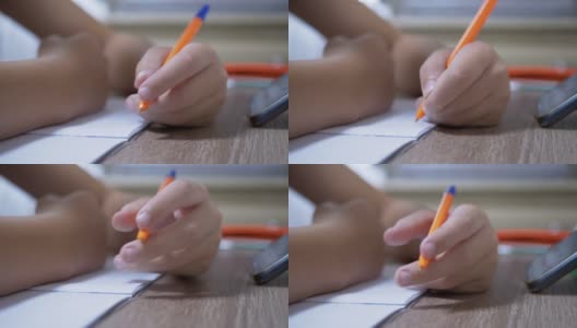 孩子用钢笔在笔记本上写字。特写镜头。4 k。慢动作高清在线视频素材下载