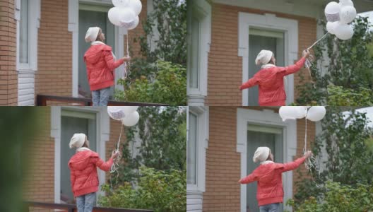 后视图十几岁的白人女孩在秋天春天的一天在户外与白色气球。自信的青少年女性生态活动家在后院与生态保护的象征高清在线视频素材下载