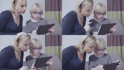 母亲和她的儿子在数码平板电脑上玩慢动作素材视频高清在线视频素材下载