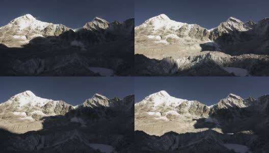 华丽的间隔拍摄。巨大的阴影在山脉表面移动，露出积雪的山顶高清在线视频素材下载
