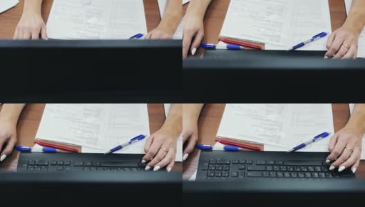 办公室工作人员的手在电脑键盘上打字的特写俯视图高清在线视频素材下载