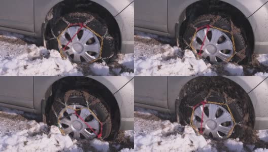 装有链条的车轮陷在雪和泥里，不停地旋转。高清在线视频素材下载