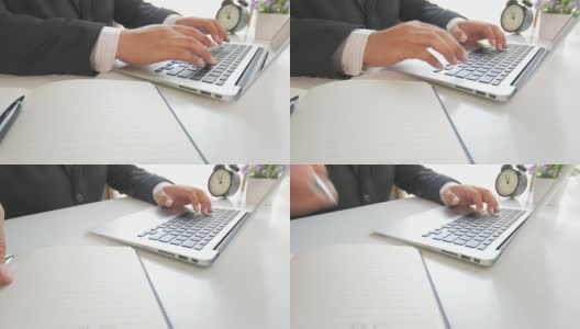 商人在笔记本键盘上打字，在笔记本上写字高清在线视频素材下载