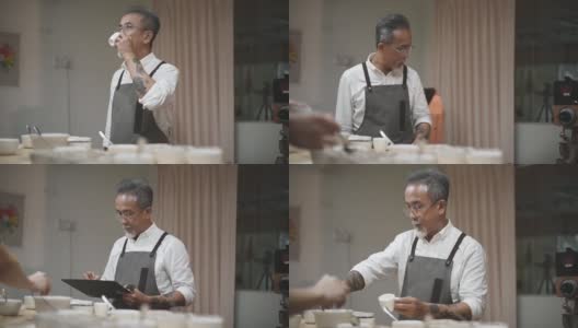 亚洲华人资深男咖啡师在工作室工作地点拔火罐品尝咖啡样品高清在线视频素材下载