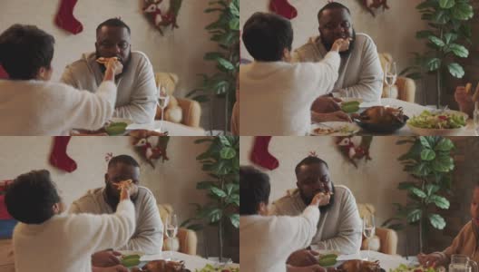 亚裔妻子给非裔美国丈夫喂披萨的家庭关系高清在线视频素材下载