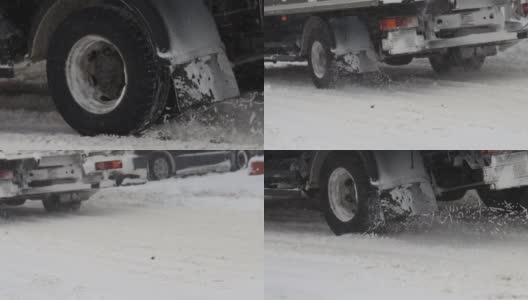 一辆卡车在冬天的雪地上行驶。用慢动作关闭车轮轮胎。交通状况不佳，暴风雪。危险之旅高清在线视频素材下载