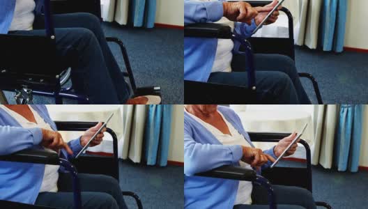 坐在轮椅上使用平板电脑的退休人士高清在线视频素材下载