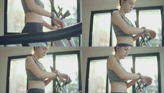 年轻的亚洲女人戴着智能手表锻炼高清在线视频素材下载