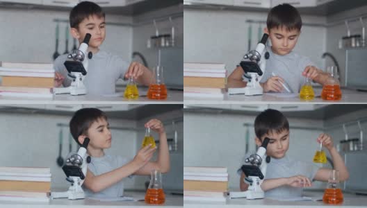 特写镜头。这个男孩用显微镜和盛有液体的瓶子教化学，并在笔记本上做笔记。家庭作业高清在线视频素材下载
