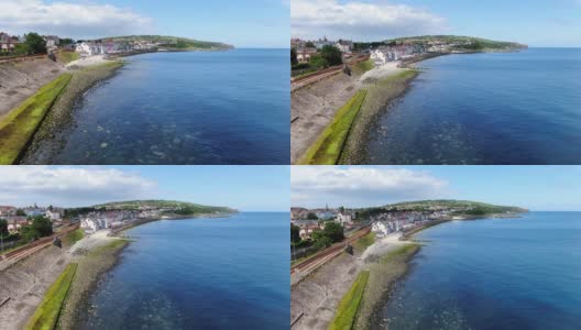 北爱尔兰怀特黑德海岸的鸟瞰图。无人机拍摄的小镇和爱尔兰海的水高清在线视频素材下载