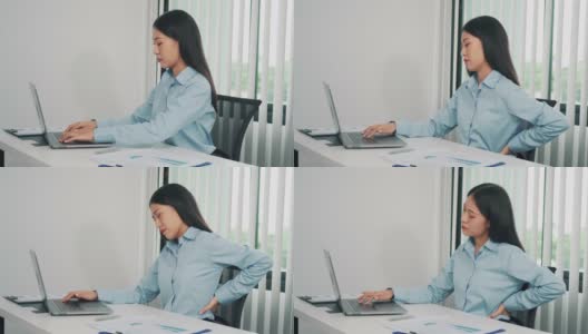 亚洲女性长时间坐着工作，按摩双手时会背痛。高清在线视频素材下载