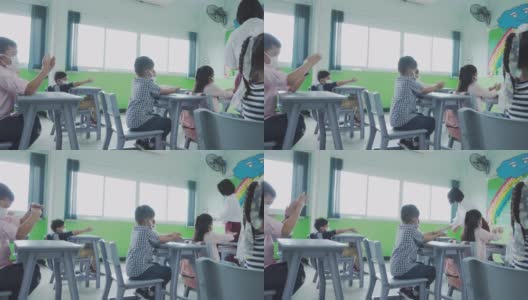 一组亚洲小学生和教师在开学后细菌的传播，新常态的教育理念。高清在线视频素材下载