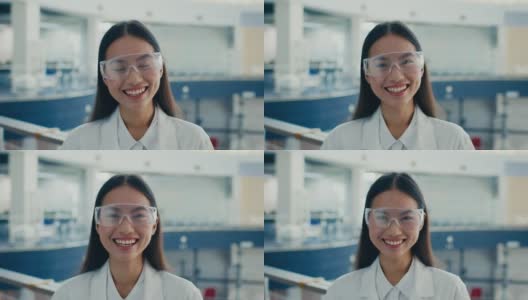 戴着防护眼镜的韩国女制造技师站在室内大笑高清在线视频素材下载