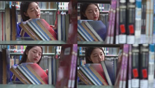 一个亚洲女人在图书馆找书的4k视频场景高清在线视频素材下载