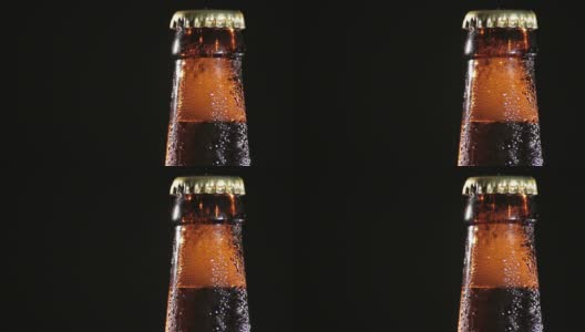 黑色背景下的冷瓶啤酒高清在线视频素材下载