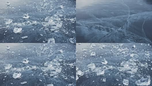 戴手套的人在冰上打碎冰。缓慢的运动。镜头移到了冰的后面。一块美丽的冰在冰的周围裂开，有神奇的裂缝。冰冻水的颗粒。高清在线视频素材下载