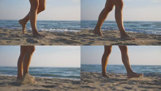 在阳光明媚的日子里，在海滩上赤脚行走的女性脚的低角度视图。年轻女子的双腿踩在沙子上。赤脚女孩在海边。波在背景。暑假或假日概念。特写慢动作高清在线视频素材下载