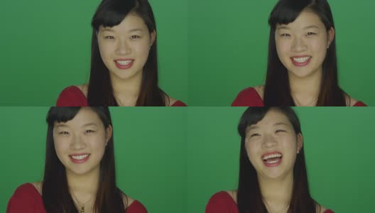 一个年轻的亚洲女人看起来非常沮丧和恼怒，在一个绿色屏幕的工作室背景高清在线视频素材下载