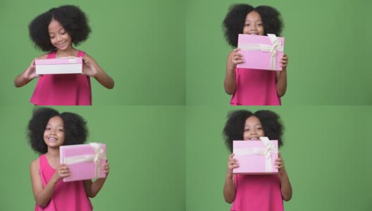 年轻可爱的非洲女孩与非洲发式拿着礼盒高清在线视频素材下载