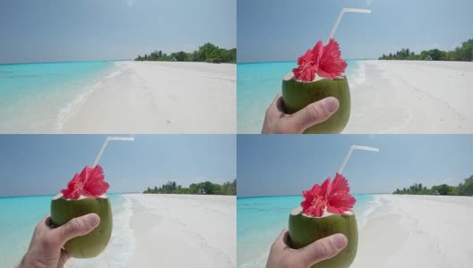 个人观点:马尔代夫阳光明媚的热带海滩上，男人喝着椰子饮料高清在线视频素材下载