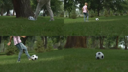 爸爸和儿子一起踢足球，习惯了孩子积极健康的生活方式高清在线视频素材下载