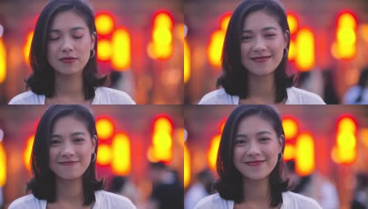 年轻亚洲女孩的肖像与城市背景微笑，4k高清在线视频素材下载