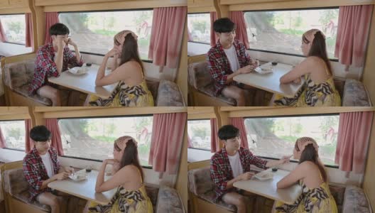 亚洲夫妇一起在露营车里吃东西度假高清在线视频素材下载