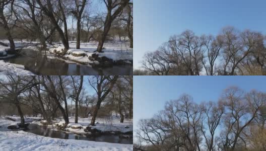 无人机从河岸上低飞离地面。冬季景观的航拍录像。高清在线视频素材下载
