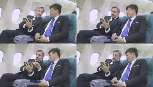 多民族商务人士在飞机上使用手机高清在线视频素材下载