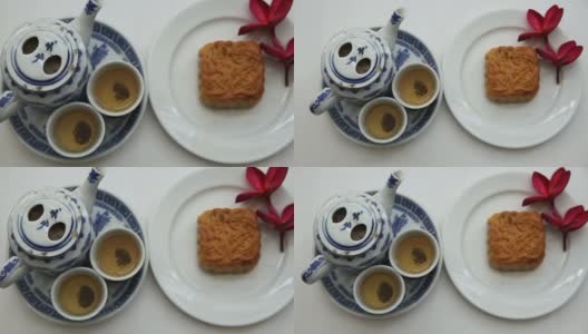 中国茶具，月饼和红色花朵，自然光线，背景高清在线视频素材下载