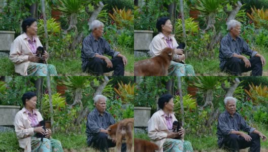 一对亚洲老夫妇坐在花园里高清在线视频素材下载