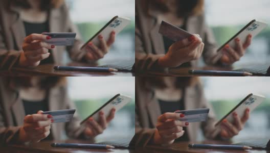女商人在手机上插入信用卡号码高清在线视频素材下载