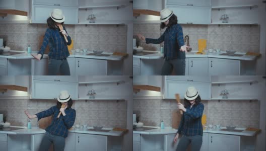 青少年黑发女孩跳舞和唱歌在厨房，好心情，女孩有乐趣在家里做饭的食物高清在线视频素材下载