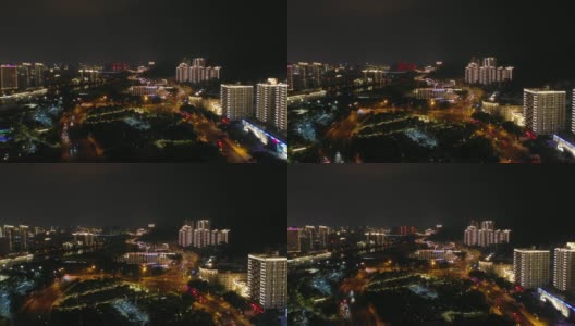 夜晚照亮三亚城市景观，河边交通，街道航拍全景4k中国海南高清在线视频素材下载