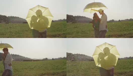 慢镜头:幸福的年轻情侣在雨中亲吻，然后继续浪漫的漫步高清在线视频素材下载