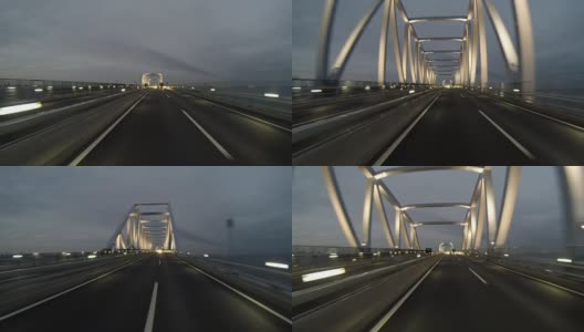 黄昏的后视图开车通过灯火通明的东京门大桥。高清在线视频素材下载