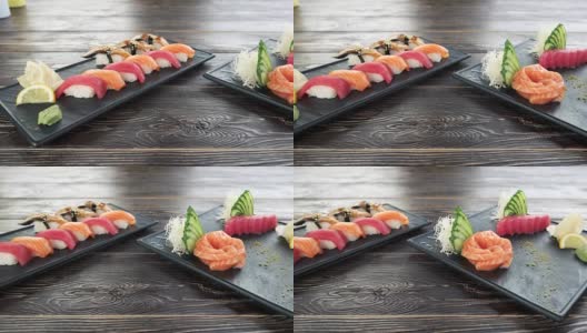手握寿司和生鱼片，木桌。高清在线视频素材下载