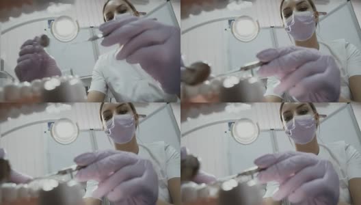 牙科医生用角探头和镜子在病人口腔内做手术高清在线视频素材下载