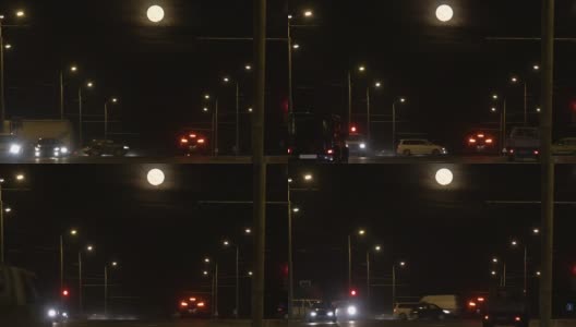 十字路口Ñar乘坐包括交通灯。夜路与灯笼离开，在满月的远方。高清在线视频素材下载