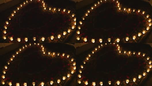 炽热的心。蜡烛排成心形。动画背景与发光的蜡烛在一个心形的电影关于情人节或关于婚礼的电影。无缝循环动画高清在线视频素材下载