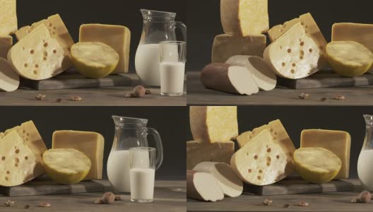 不同种类的奶酪和牛奶罐放在木桌上高清在线视频素材下载