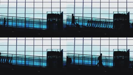 日落剪影的通勤者在机场。高清在线视频素材下载