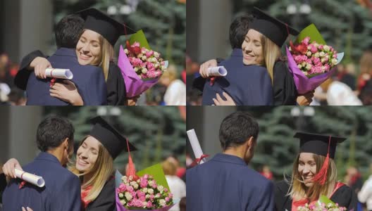 兴奋的女青年抱着男青年相对幸福，恭喜毕业高清在线视频素材下载