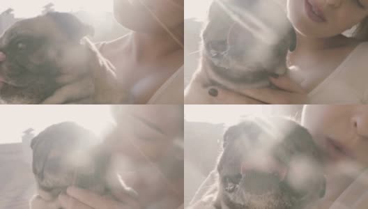 年轻女子亲吻她的狗高清在线视频素材下载