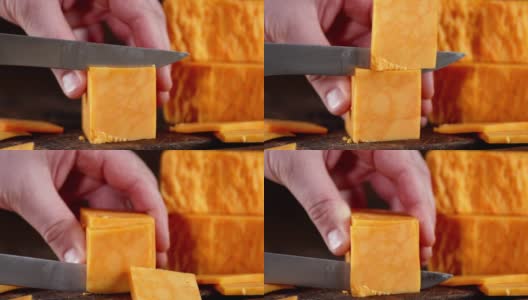 男用刀将切达干酪切成小块。高清在线视频素材下载