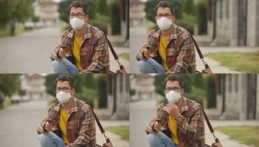 年轻成年男性戴口罩以防止污染或冠状病毒高清在线视频素材下载