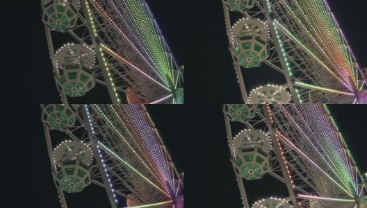 摩天轮的夜景。明亮的彩色灯。高清在线视频素材下载