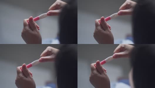 亚洲妇女的手与阳性妊娠测试高清在线视频素材下载