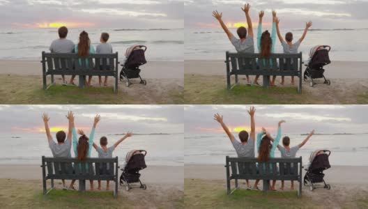 幸福的一家人坐在海边一起看日落。高清在线视频素材下载