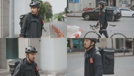 亚洲快递员走路，拖着自行车高清在线视频素材下载